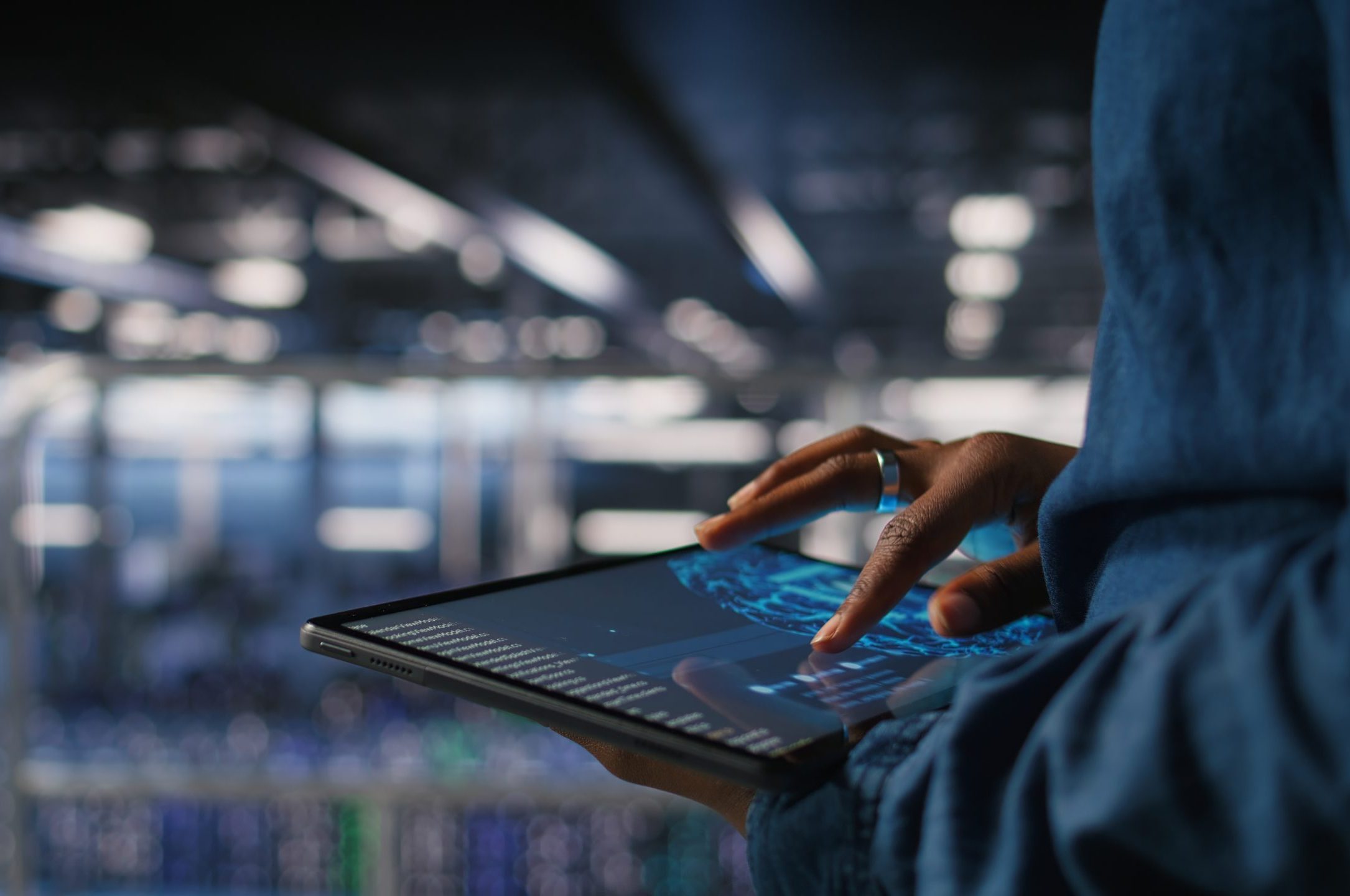 Close up of data center engineer using tablet, doing maintenance on AI rigs