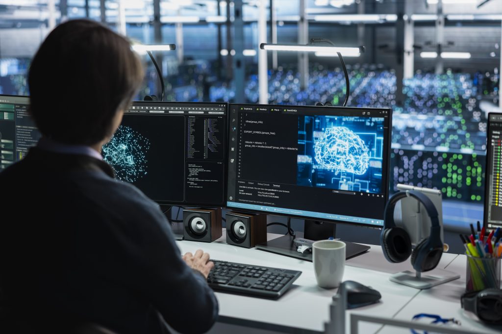 Data center engineer using PC, adjusting AI model parameters